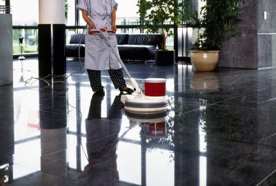 Adult cleaner maid woman with uniform cleaning corridor pass floor