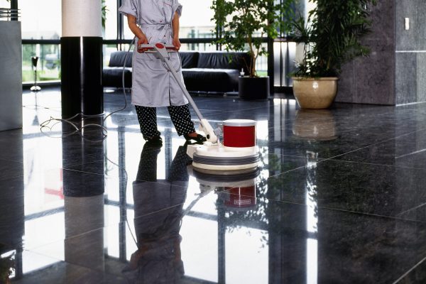 Adult cleaner maid woman with uniform cleaning corridor pass floor